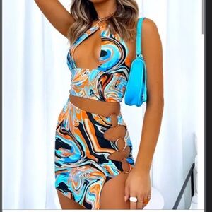 Vibrant Cut-Out Swirl Dress with Blue Bag